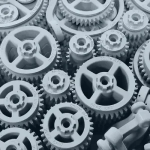 A laser beam fuses nylon powder on a flat bed, forming durable and intricate parts in a high-temperature, powder-based 3D printing process.