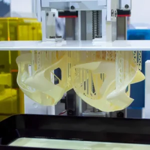 A UV laser cures liquid resin layer by layer, producing highly detailed and smooth 3D prints with exceptional accuracy and fine surface finish.